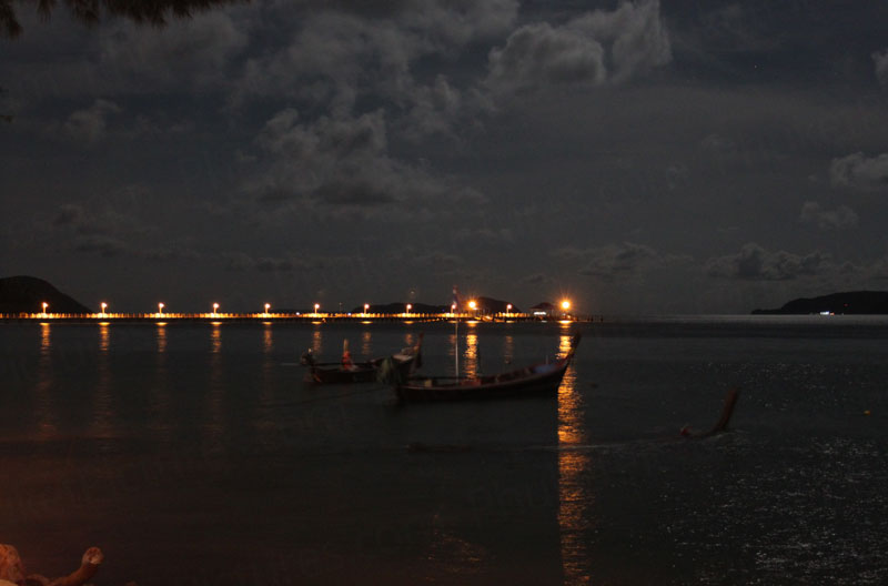 View from Rawai Beach at night with pier in background